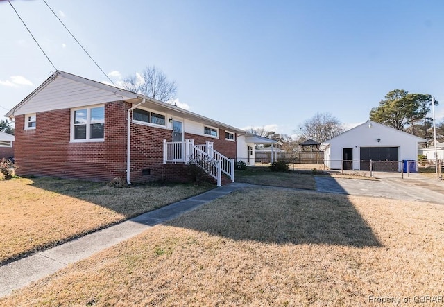 view of front facade featuring a garage, an outdoor structure, and a front lawn