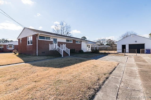 ranch-style house with a garage, an outbuilding, and a front lawn