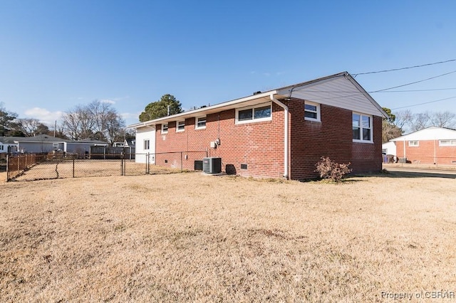 rear view of property with central AC