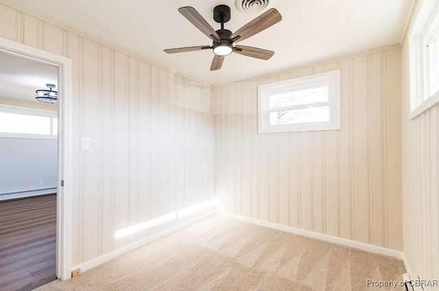 carpeted empty room with baseboard heating and ceiling fan