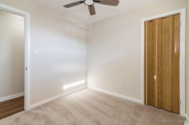 unfurnished bedroom with light carpet and ceiling fan