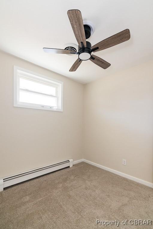 spare room featuring carpet flooring, ceiling fan, and baseboard heating