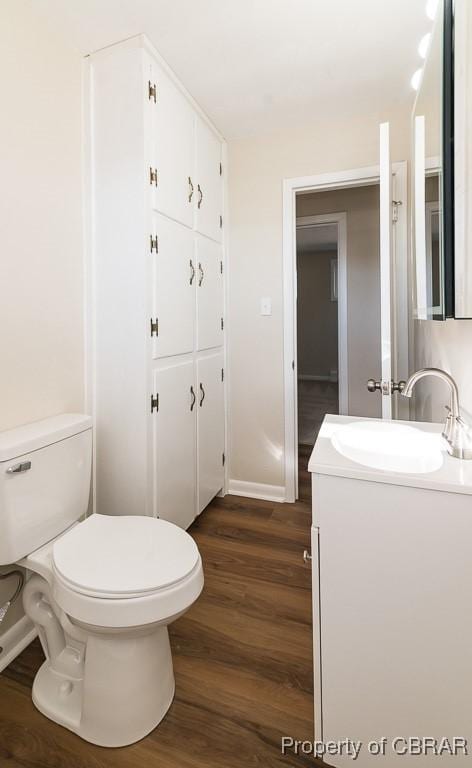 bathroom featuring vanity, wood-type flooring, and toilet