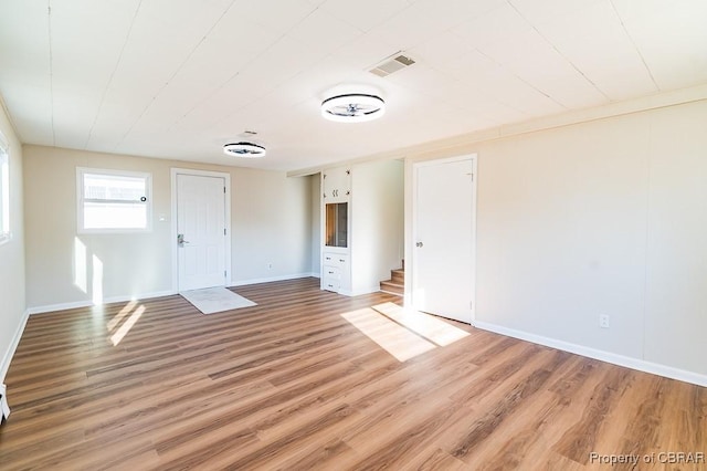 empty room with hardwood / wood-style floors