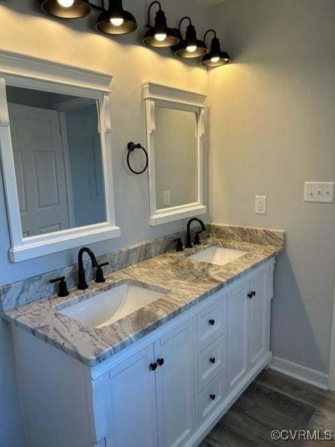 bathroom with vanity and wood-type flooring