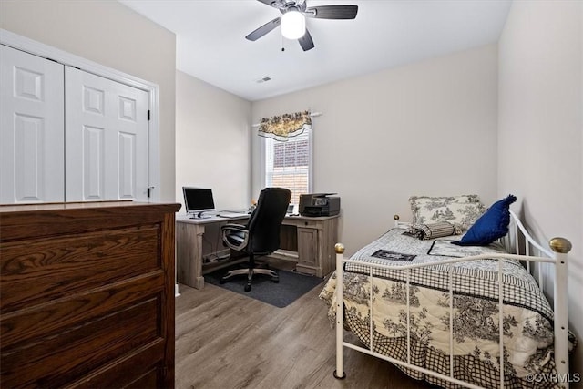 bedroom with wood-type flooring and ceiling fan