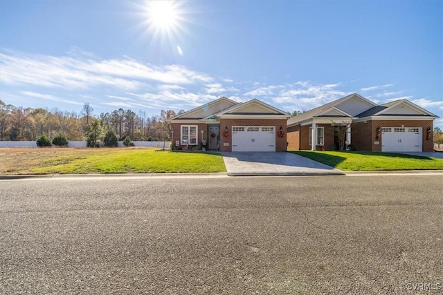 craftsman inspired home with a garage and a front lawn