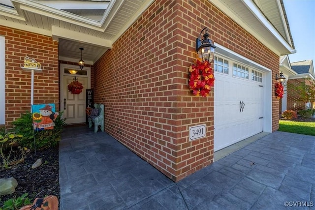 doorway to property with a garage