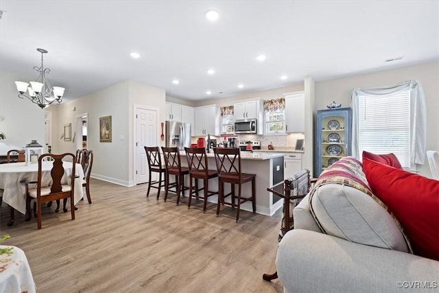 living room featuring light hardwood / wood-style flooring and a chandelier