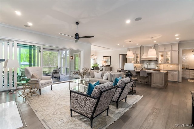 living room with ceiling fan, ornamental molding, sink, and dark hardwood / wood-style flooring