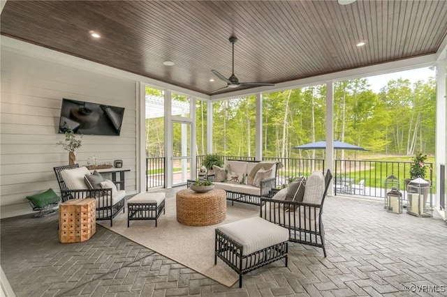 sunroom featuring wooden ceiling and ceiling fan