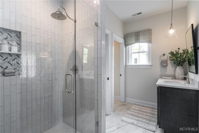 bathroom with vanity and a shower with shower door