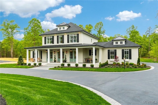 view of front facade with a porch and a front lawn