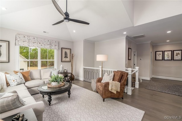 living room with crown molding, vaulted ceiling, and dark hardwood / wood-style floors