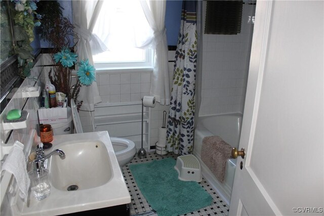 full bathroom featuring vanity, shower / bath combination with curtain, and toilet