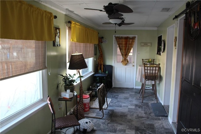 interior space with ceiling fan