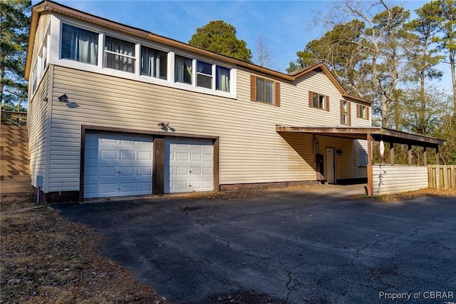 view of front of property featuring a garage and a carport