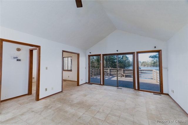 unfurnished room with high vaulted ceiling