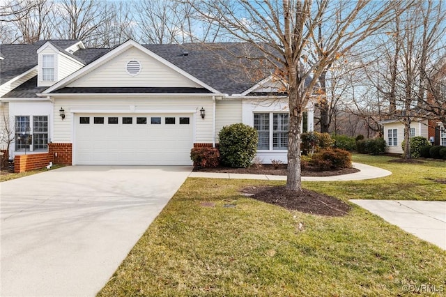 view of front of house with a garage and a front lawn