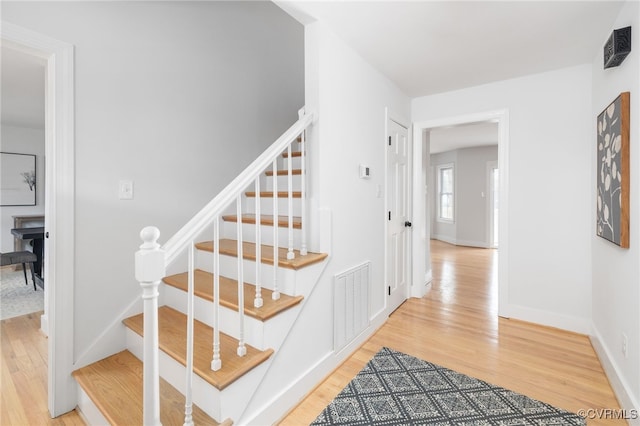 stairs with hardwood / wood-style flooring