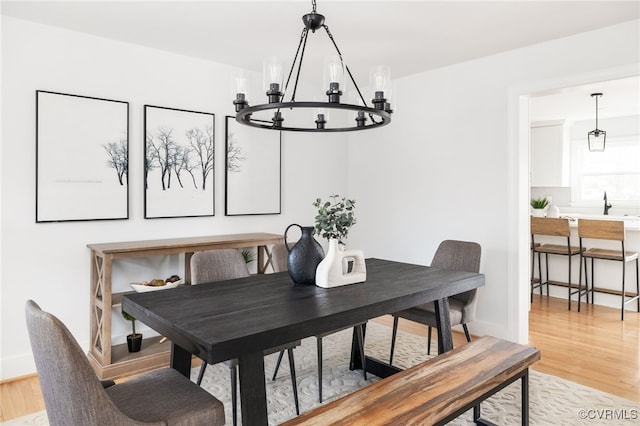 dining area featuring a notable chandelier and light hardwood / wood-style flooring