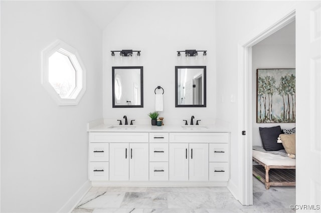 bathroom featuring vanity and vaulted ceiling