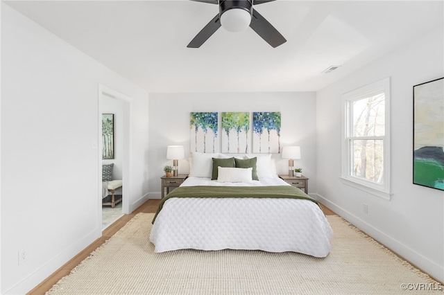 bedroom with wood-type flooring and ceiling fan