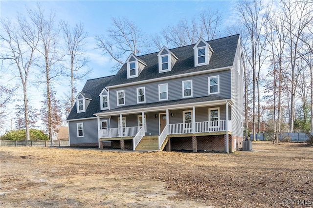 cape cod-style house with central AC and covered porch