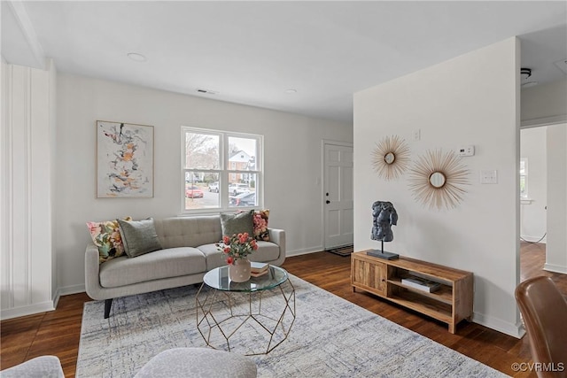 living room with dark hardwood / wood-style flooring