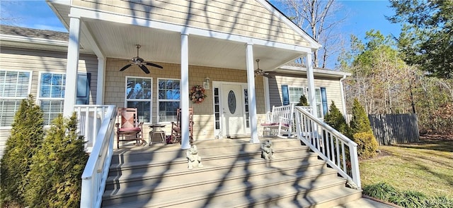 deck with a lawn, ceiling fan, and a porch