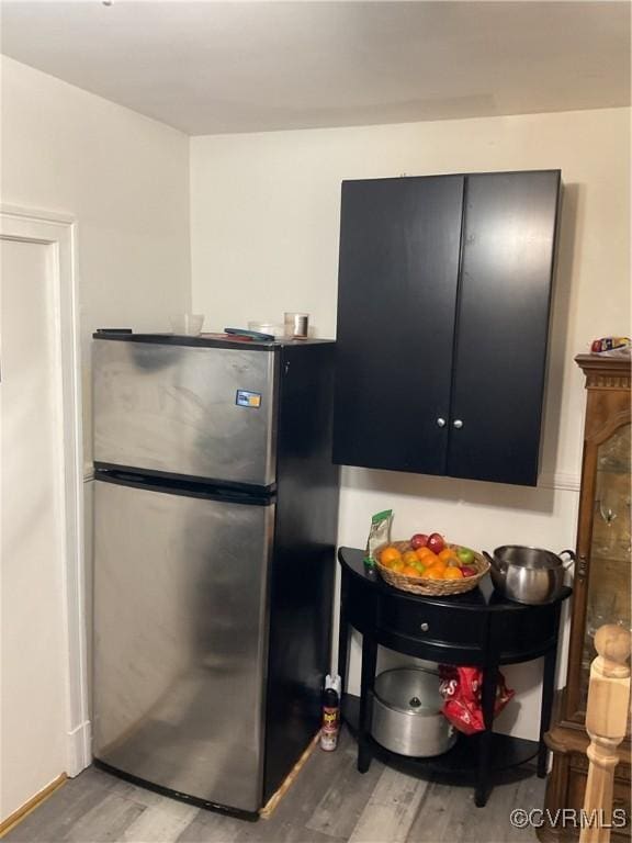 kitchen featuring wood-type flooring and stainless steel refrigerator