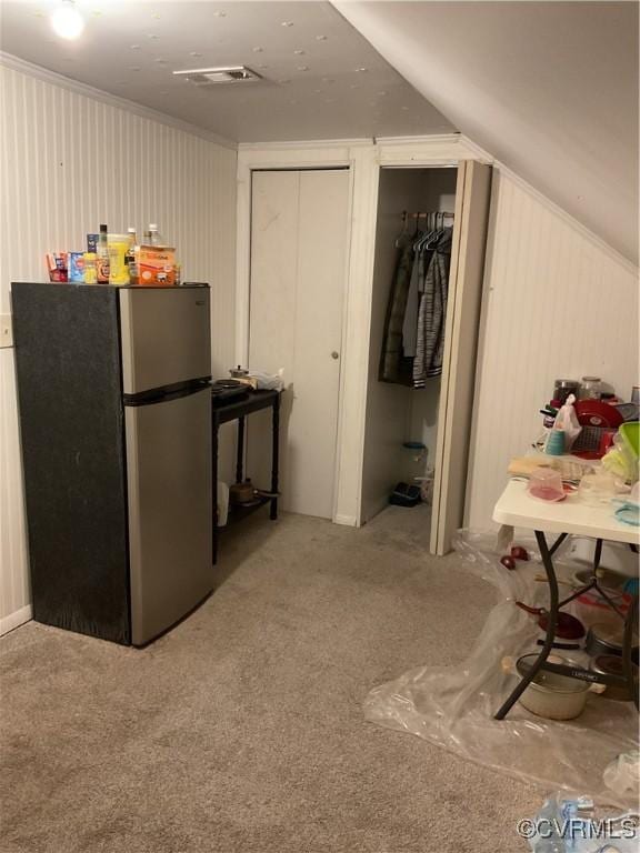 interior space with stainless steel refrigerator and carpet flooring