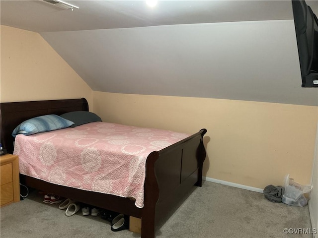 carpeted bedroom with vaulted ceiling