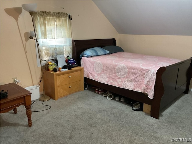 carpeted bedroom with vaulted ceiling