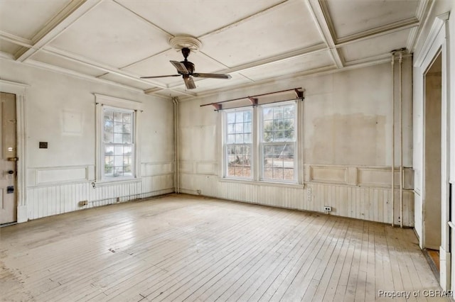 miscellaneous room with coffered ceiling, ceiling fan, light hardwood / wood-style floors, crown molding, and beam ceiling