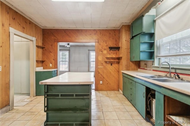 kitchen featuring sink, green cabinets, a kitchen island, and light tile patterned floors