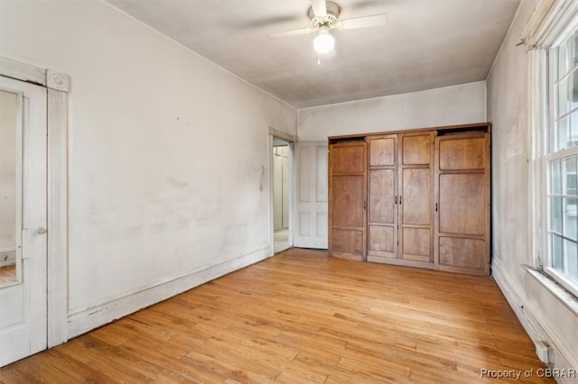 unfurnished bedroom with ceiling fan and light hardwood / wood-style floors