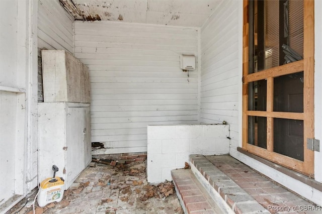 bathroom featuring wood walls