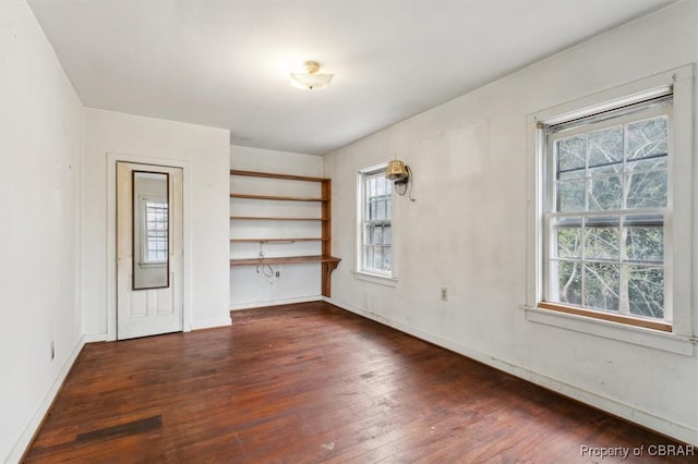 unfurnished room featuring dark wood-type flooring