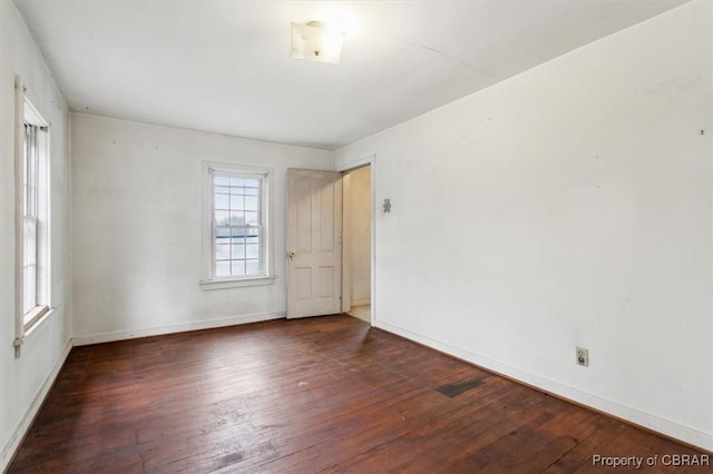 spare room with dark hardwood / wood-style floors