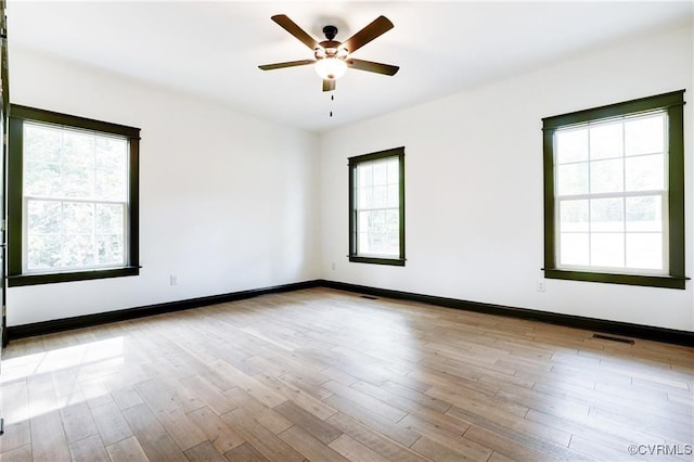 spare room featuring ceiling fan and light hardwood / wood-style flooring