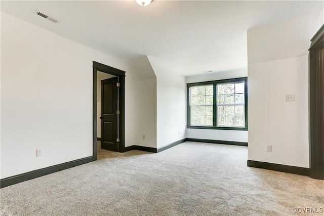 empty room featuring light colored carpet