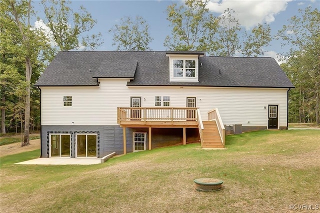 back of house with central AC unit, a lawn, and a deck