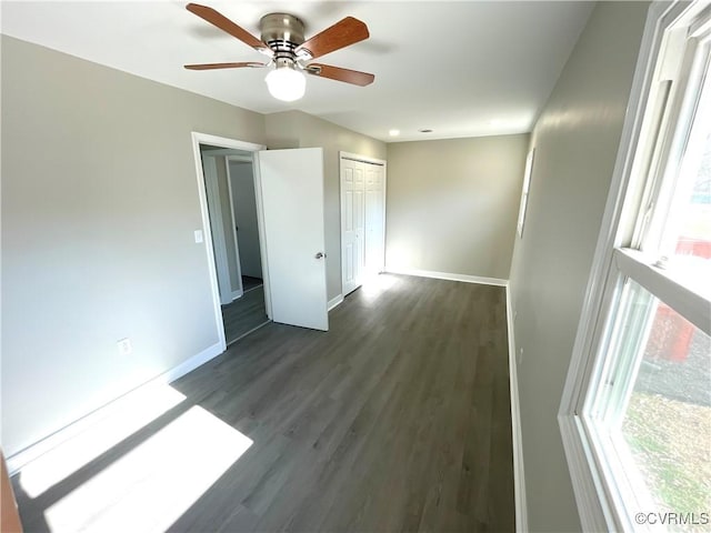 spare room featuring dark hardwood / wood-style flooring and ceiling fan