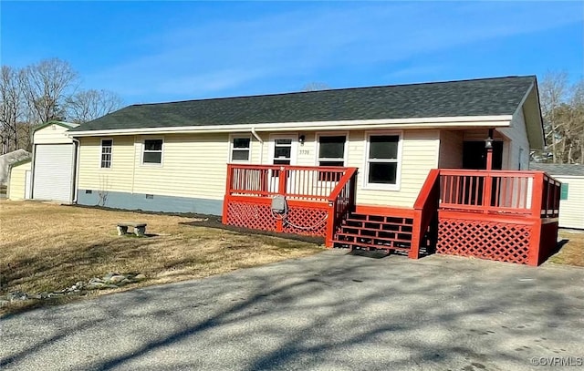 exterior space featuring a deck and a lawn