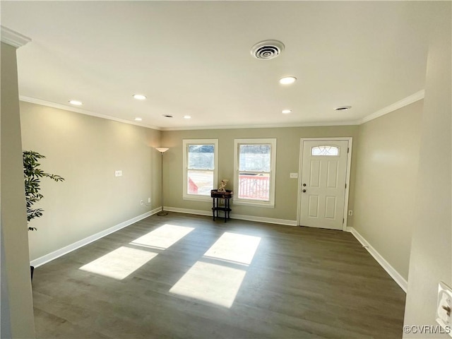 foyer featuring crown molding and dark wood-type flooring