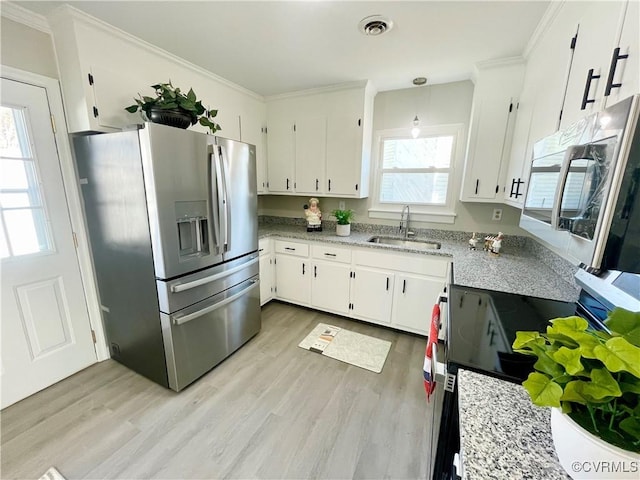 kitchen with white cabinetry, light wood-type flooring, ornamental molding, pendant lighting, and stainless steel appliances