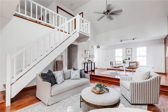 living room featuring ceiling fan, high vaulted ceiling, and hardwood / wood-style floors