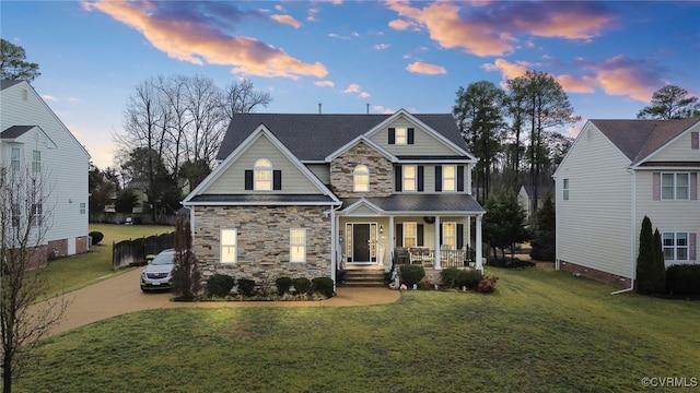 craftsman-style home featuring a lawn and covered porch