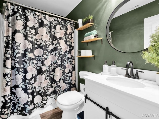 bathroom featuring hardwood / wood-style flooring, vanity, and toilet